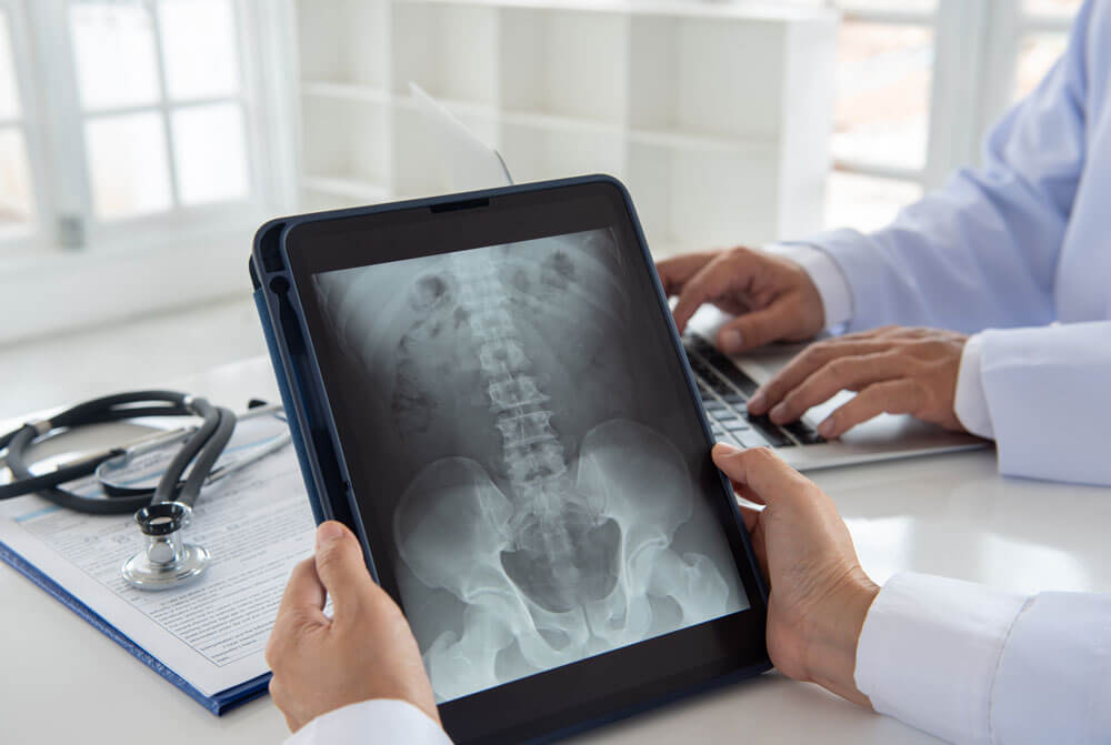 CT scans and X-rays, shown here on a tablet, help doctors diagnose patients' concerns.